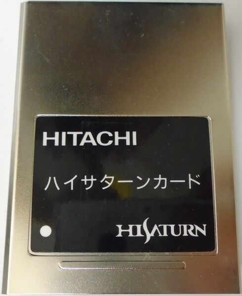 Metallic card with Hitachi and Hisaturn branding on a reflective surface